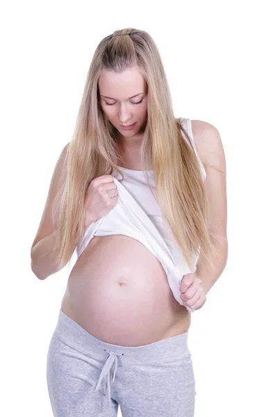 Levetkőzött terhes nő mellét gazdaság — Stock Fotó